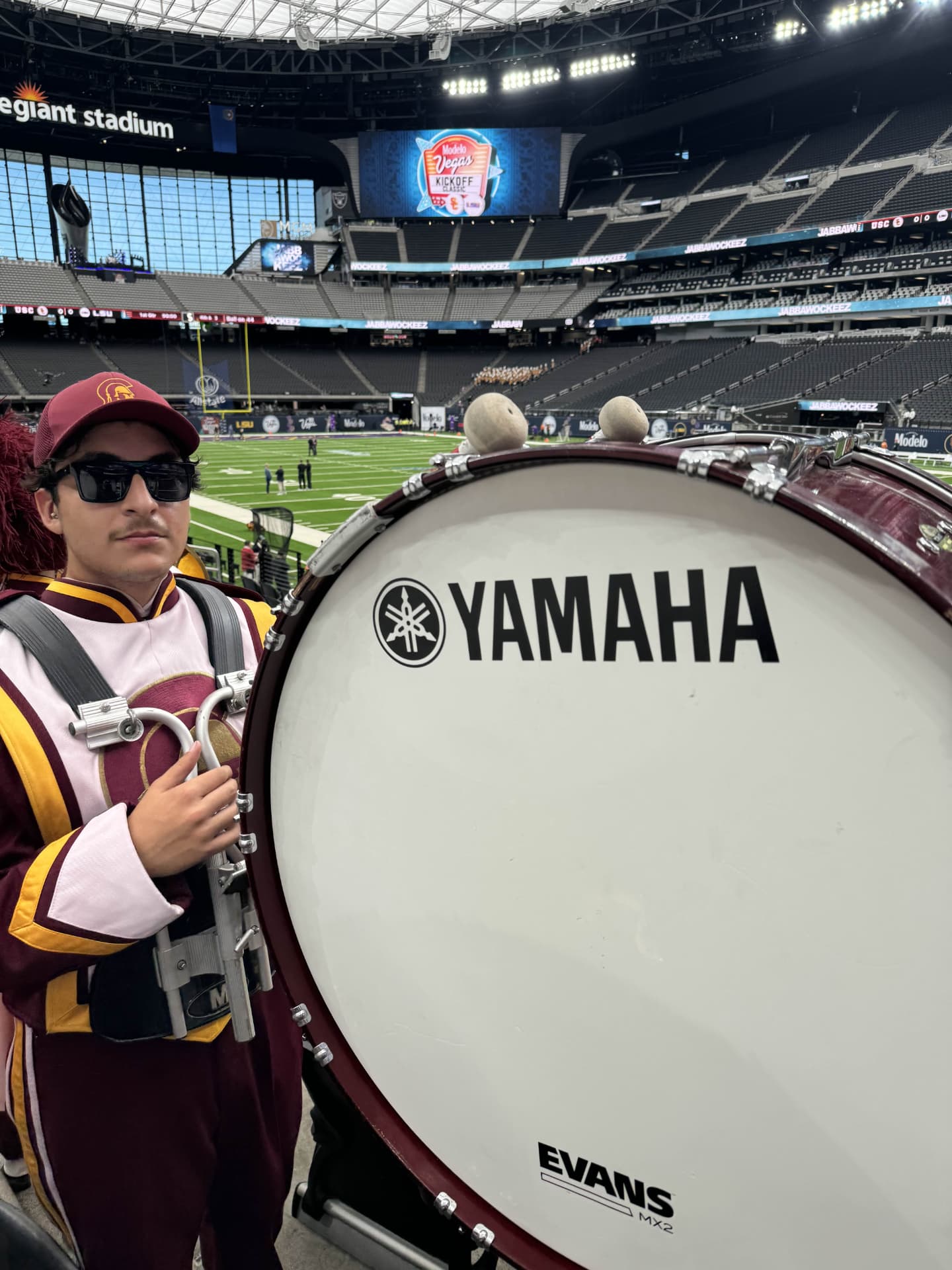Ian Cervantes with a bass drum while performing with the USC marching band at Allegiant Stadium